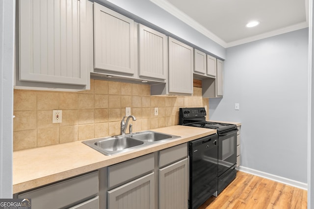 kitchen featuring black appliances, a sink, gray cabinetry, ornamental molding, and tasteful backsplash