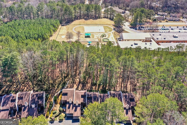 aerial overview of property's location with a heavily wooded area