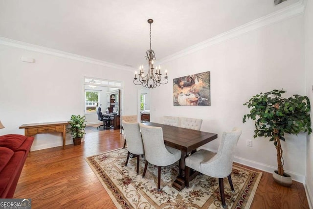 306 Cherokee Station Cir, Woodstock, GA 30188 - dining room with crown molding, a chandelier, and wood finished floors
