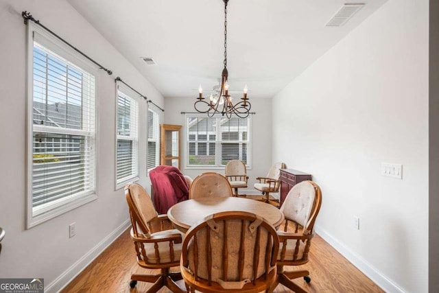 306 Cherokee Station Cir, Woodstock, GA 30188 - dining area with light wood finished floors and a chandelier