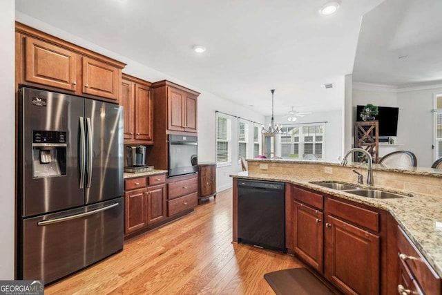 306 Cherokee Station Cir, Woodstock, GA 30188 - kitchen featuring appliances with stainless steel finishes, light wood-style floors, light stone countertops, hanging light fixtures, and recessed lighting