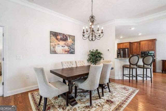 306 Cherokee Station Cir, Woodstock, GA 30188 - dining area with a chandelier, wood finished floors, ornamental molding, and recessed lighting