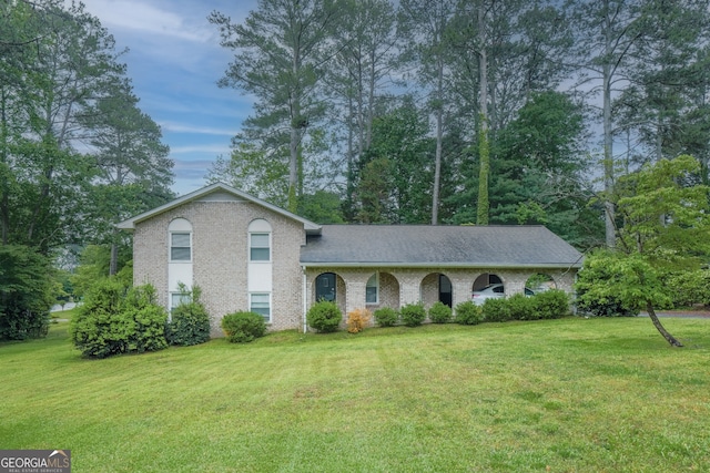 4244 Dorsey Ct SW, Lilburn, GA 30047 - split level home with a front yard, brick siding, and roof with shingles