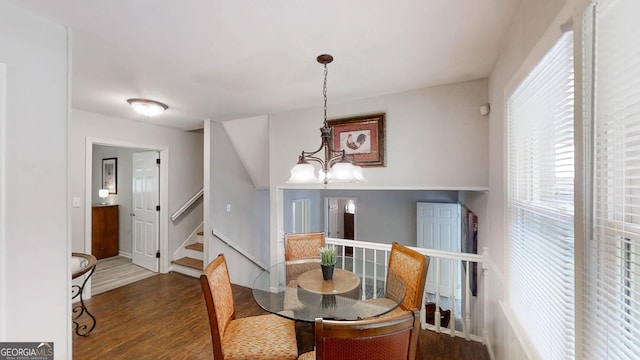 4244 Dorsey Ct SW, Lilburn, GA 30047 - dining area featuring wood finished floors, stairs, a chandelier, and baseboards
