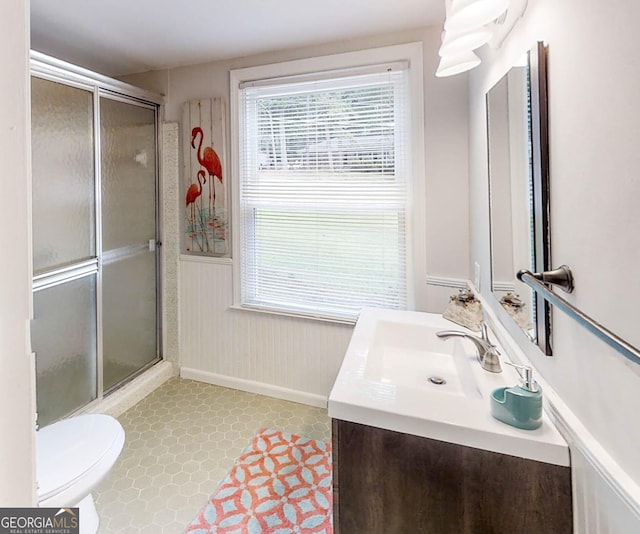 4244 Dorsey Ct SW, Lilburn, GA 30047 - full bath featuring a stall shower, a wainscoted wall, baseboards, vanity, and toilet