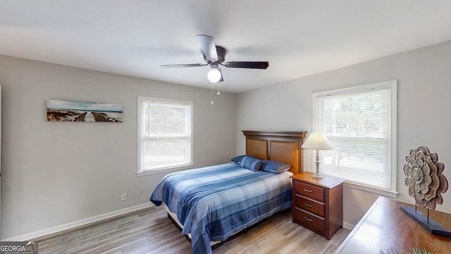 4244 Dorsey Ct SW, Lilburn, GA 30047 - bedroom with light wood-style floors, baseboards, and a ceiling fan