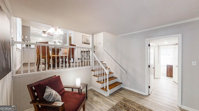 4244 Dorsey Ct SW, Lilburn, GA 30047 - stairway with wood finished floors, baseboards, ornamental molding, and a chandelier