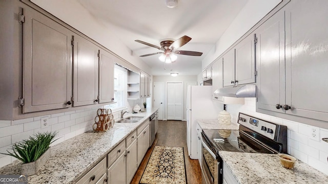 4244 Dorsey Ct SW, Lilburn, GA 30047 - kitchen with stainless steel appliances, under cabinet range hood, ceiling fan, decorative backsplash, and wood finished floors
