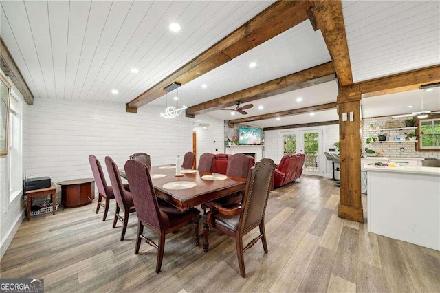 dining space featuring light wood finished floors, recessed lighting, beam ceiling, ceiling fan, and french doors