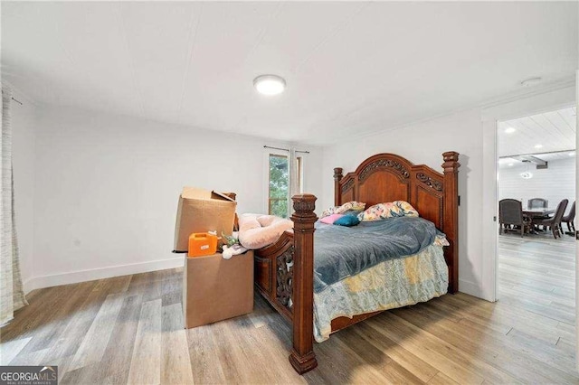 bedroom featuring wood finished floors and baseboards