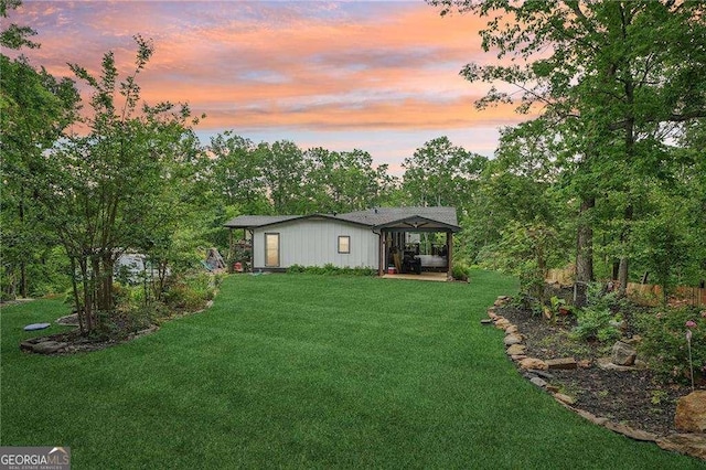 back of house featuring a patio and a lawn