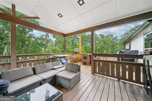 wooden terrace with an outdoor living space and view of scattered trees
