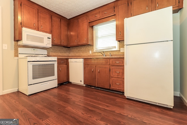 5243 Valleyview Dr, Acworth, GA 30102 - kitchen with white appliances, brown cabinetry, and dark wood-type flooring