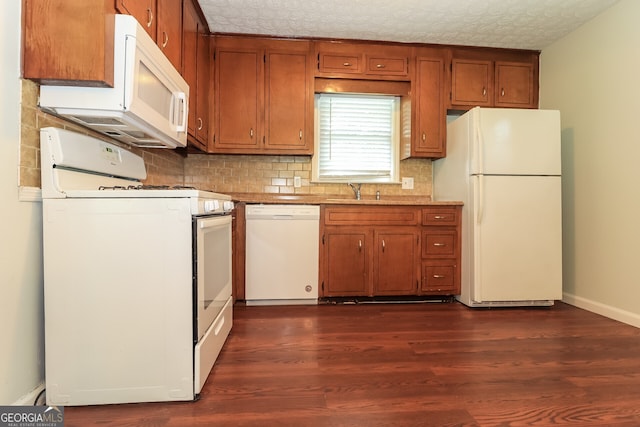 5243 Valleyview Dr, Acworth, GA 30102 - kitchen with white appliances, dark wood-style floors, brown cabinetry, and backsplash