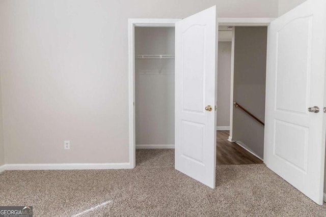 7623 Mcgillicuty Dr, Union City, GA 30291 - unfurnished bedroom featuring carpet floors, a closet, baseboards, and a walk in closet