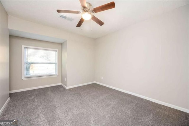 unfurnished room featuring dark carpet, baseboards, and a ceiling fan