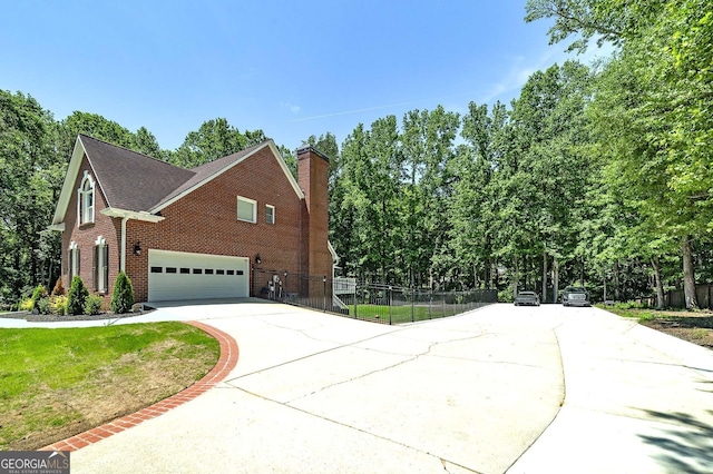 20 Allie Dr, Mcdonough, GA 30252 - view of property exterior featuring concrete driveway, brick siding, fence, a garage, and a chimney