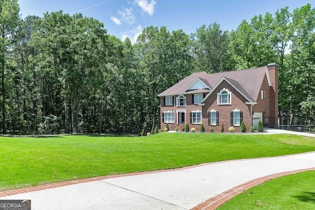 20 Allie Dr, Mcdonough, GA 30252 - colonial house featuring brick siding, a chimney, and a front yard