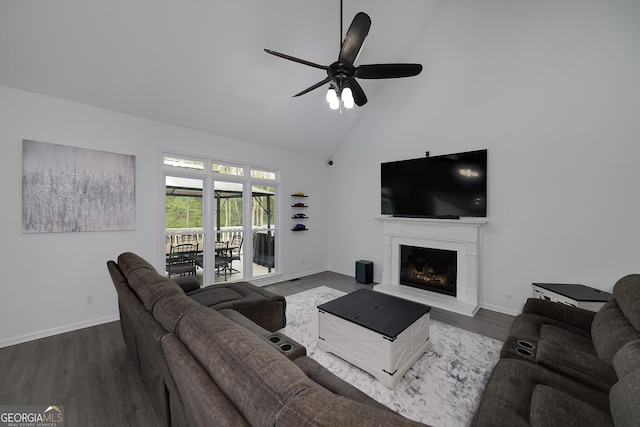 20 Allie Dr, Mcdonough, GA 30252 - living area featuring dark wood finished floors, a ceiling fan, high vaulted ceiling, baseboards, and a fireplace with raised hearth