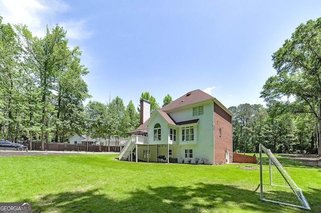 20 Allie Dr, Mcdonough, GA 30252 - back of property with stairs, a chimney, fence, and a deck