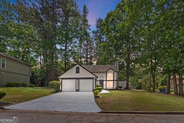 5383 Biffle Way, Stone Mountain, GA 30088 - view of front of home with driveway, a front yard, a chimney, and an attached garage