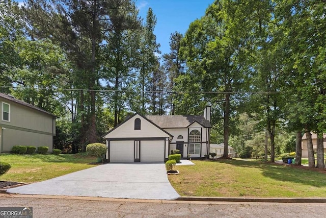 5383 Biffle Way, Stone Mountain, GA 30088 - view of front of home featuring concrete driveway, a front lawn, a chimney, and a garage