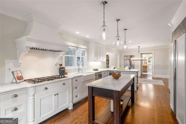 1041 Standard Dr, Brookhaven, GA 30319 - kitchen featuring a sink, ornamental molding, a peninsula, light countertops, and white cabinetry