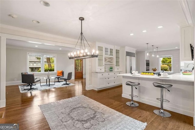 1041 Standard Dr, Brookhaven, GA 30319 - kitchen featuring plenty of natural light, white cabinetry, glass insert cabinets, crown molding, and recessed lighting