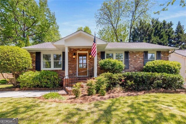 1041 Standard Dr, Brookhaven, GA 30319 - single story home featuring a front yard and brick siding