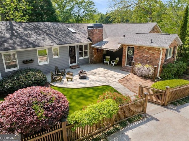 1041 Standard Dr, Brookhaven, GA 30319 - back of house featuring a fire pit, a patio area, a chimney, and roof with shingles
