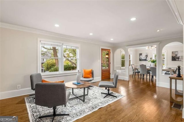 1041 Standard Dr, Brookhaven, GA 30319 - living room featuring crown molding, baseboards, arched walkways, recessed lighting, and wood finished floors