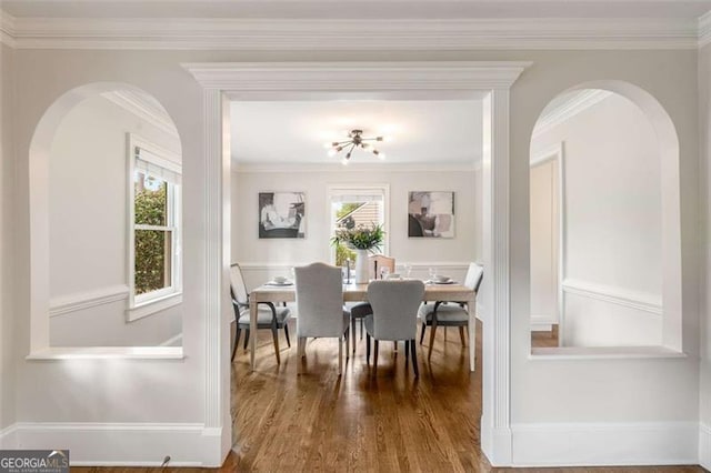 1041 Standard Dr, Brookhaven, GA 30319 - dining room with arched walkways, wood finished floors, and crown molding