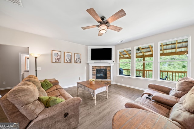 433 Crystal Way, Cornelia, GA 30531 - living room with ceiling fan, baseboards, wood finished floors, and a stone fireplace