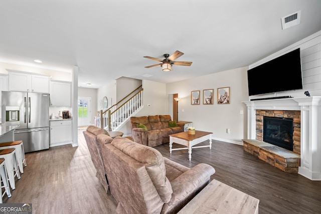 433 Crystal Way, Cornelia, GA 30531 - living area with stairway, a stone fireplace, ceiling fan, and dark wood-style floors