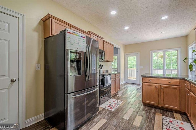188 Cooper Creek Dr, Dallas, GA 30157 - kitchen with stainless steel appliances, a textured ceiling, brown cabinets, dark wood-style flooring, and baseboards