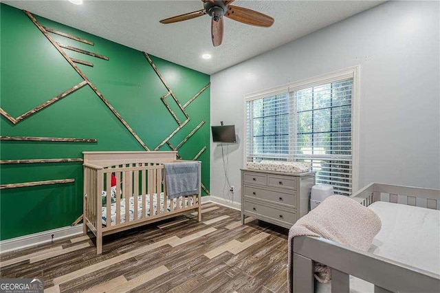 188 Cooper Creek Dr, Dallas, GA 30157 - bedroom with wood finished floors, ceiling fan, a textured ceiling, baseboards, and recessed lighting