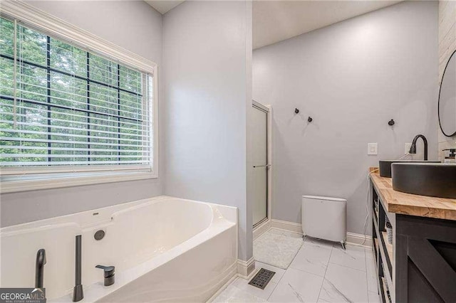 188 Cooper Creek Dr, Dallas, GA 30157 - bathroom with healthy amount of natural light, a garden tub, baseboards, and a stall shower