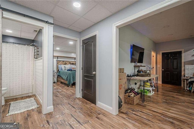188 Cooper Creek Dr, Dallas, GA 30157 - hallway featuring wood finished floors, baseboards, a barn door, and recessed lighting