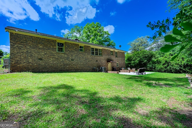347 Brookridge Dr, Lagrange, GA 30241 - rear view of house featuring a patio, central AC unit, a lawn, and brick siding