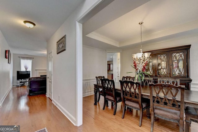 25 Kaktovic Ct, Grayson, GA 30017 - dining area featuring light wood finished floors, a chandelier, crown molding, and a raised ceiling