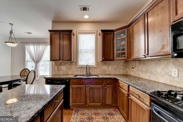 25 Kaktovic Ct, Grayson, GA 30017 - kitchen with black appliances, a sink, plenty of natural light, and dark stone countertops