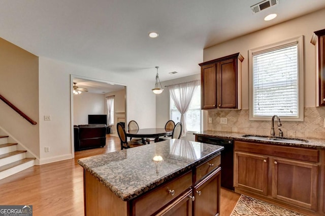 25 Kaktovic Ct, Grayson, GA 30017 - kitchen featuring a sink, dishwasher, dark stone counters, a kitchen island, and recessed lighting