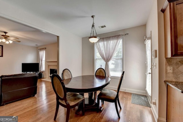 25 Kaktovic Ct, Grayson, GA 30017 - dining area with light wood-style flooring, plenty of natural light, and a fireplace