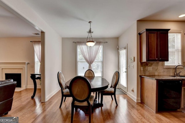 25 Kaktovic Ct, Grayson, GA 30017 - dining room featuring light wood finished floors, plenty of natural light, and baseboards