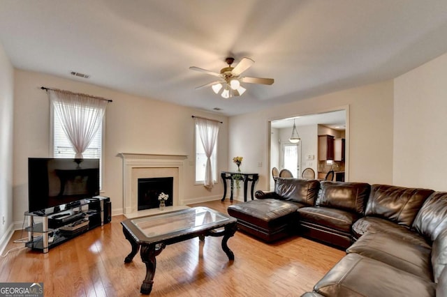 25 Kaktovic Ct, Grayson, GA 30017 - living room with ceiling fan, wood finished floors, a high end fireplace, and baseboards