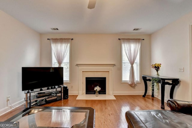 25 Kaktovic Ct, Grayson, GA 30017 - living room with wood finished floors, a ceiling fan, a fireplace, and baseboards