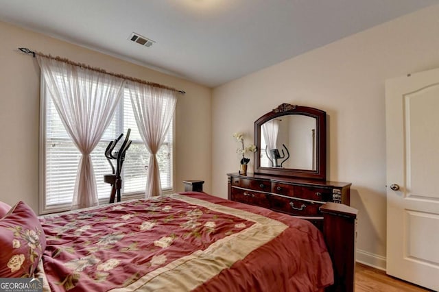 25 Kaktovic Ct, Grayson, GA 30017 - bedroom featuring multiple windows, light wood-style floors, and baseboards