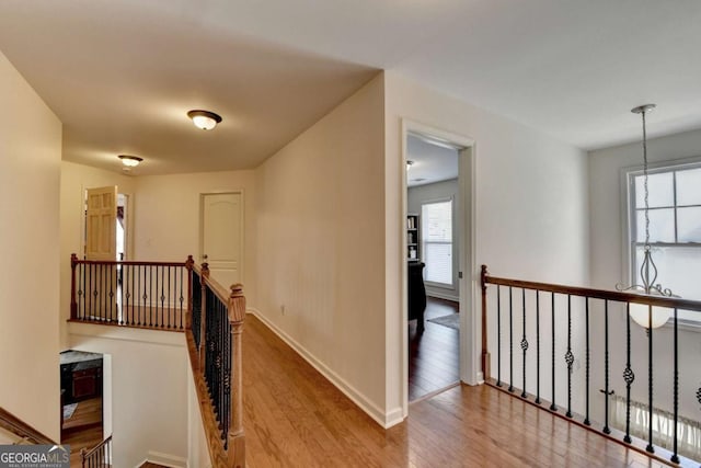 25 Kaktovic Ct, Grayson, GA 30017 - hallway featuring an upstairs landing, wood finished floors, and baseboards