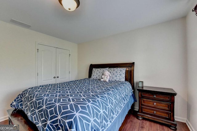 25 Kaktovic Ct, Grayson, GA 30017 - bedroom with wood finished floors, a closet, and baseboards