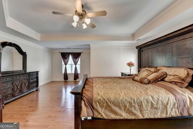 25 Kaktovic Ct, Grayson, GA 30017 - bedroom with a tray ceiling, light wood-style floors, crown molding, baseboards, and ceiling fan
